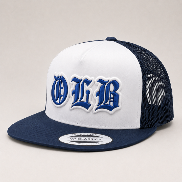 🤍 Royal Blue White – Old English 3D Puff · Royal blue fill · White puff outline · Navy white flat trucker | Hand Finished in Dubai | EmbroMania