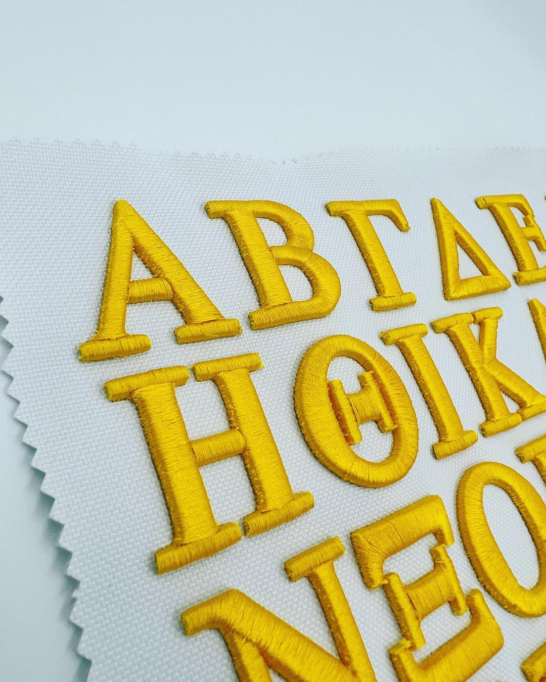 Olympus Greek 3D Puff – Full Greek Alphabet Close-Up · Gold Thread on White Fabric · Machine Embroidered Reference Sheet | Hand Finished in Dubai | EmbroMania