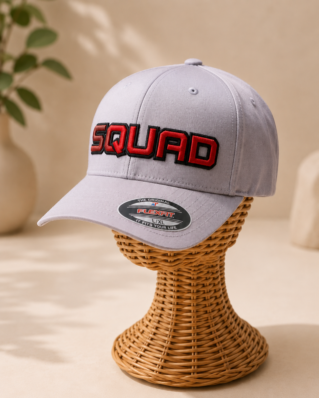 "SquadOutline two-layer 3D puff embroidery spelling SQUAD in Bold Statement — white cap with jet black outline and vibrant red puff fill"