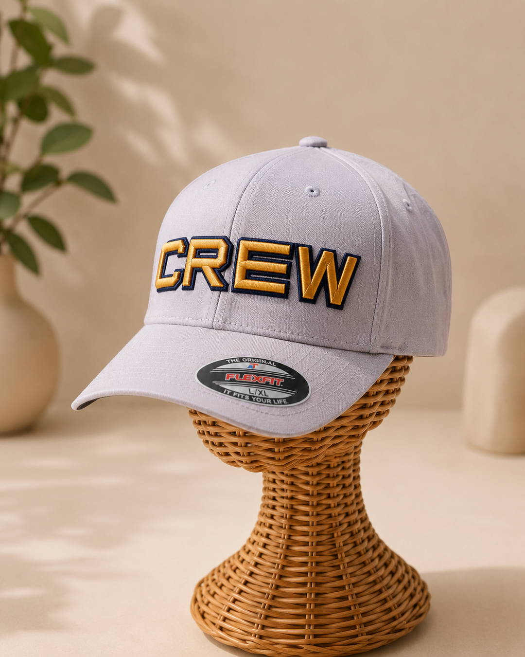 SquadOutline two-layer 3D puff embroidery spelling CREW in Corporate Refinement — gray cap with navy outline and rich gold puff fill