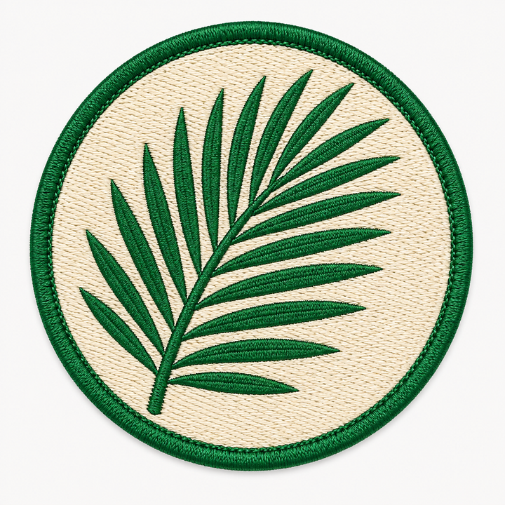 Tropic Palm Frond embroidery patch featuring a simple palm leaf frond shape in flat tropical green | Hand Finished in Dubai | EmbroMania